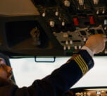 airplane captain starting engine with power buttons dashboard fly plane from cockpit pushing switch lever takeoff using control panel command with windscreen compass