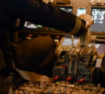 aviation crew flying airplane with engine lever throttle using dashboard command buttons takeoff control panel navigantion windscreen fly plane using power handle close up