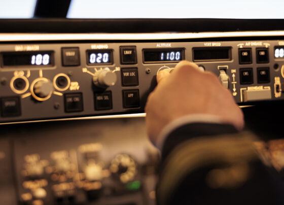 captain pushing buttons fix altitude level control panel command using navigation switch fly airplane jet power radar with dashboard handle takeoff with plane close up