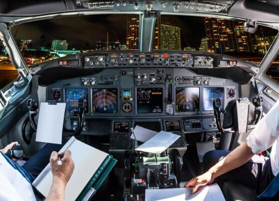 midsection pilots holding paper cockpit cityscape 1048944 20219616